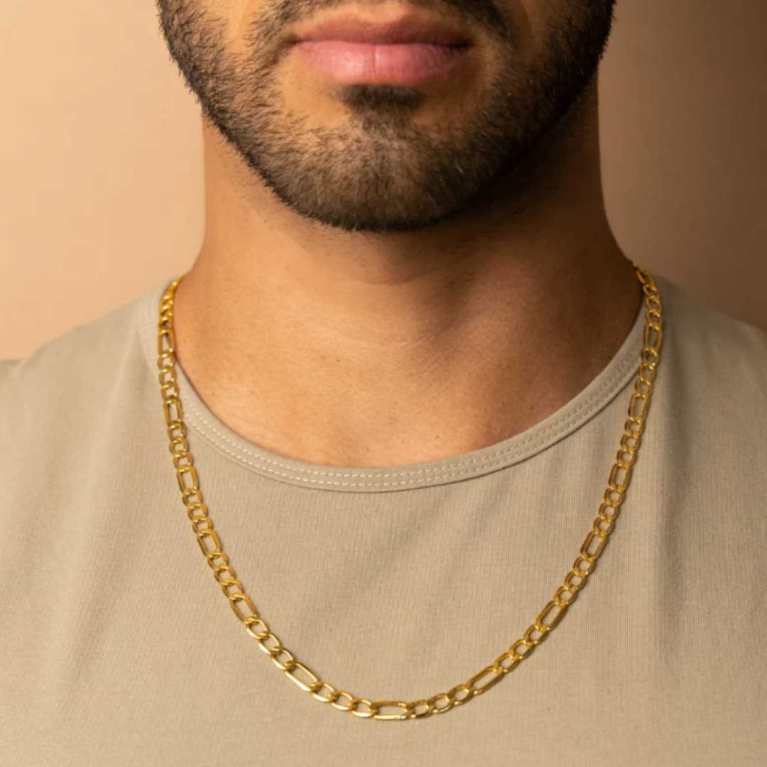 Men's model showcasing the Figaro Chain in 18K Gold, featuring bold 7MM links for a striking and sophisticated accessory.