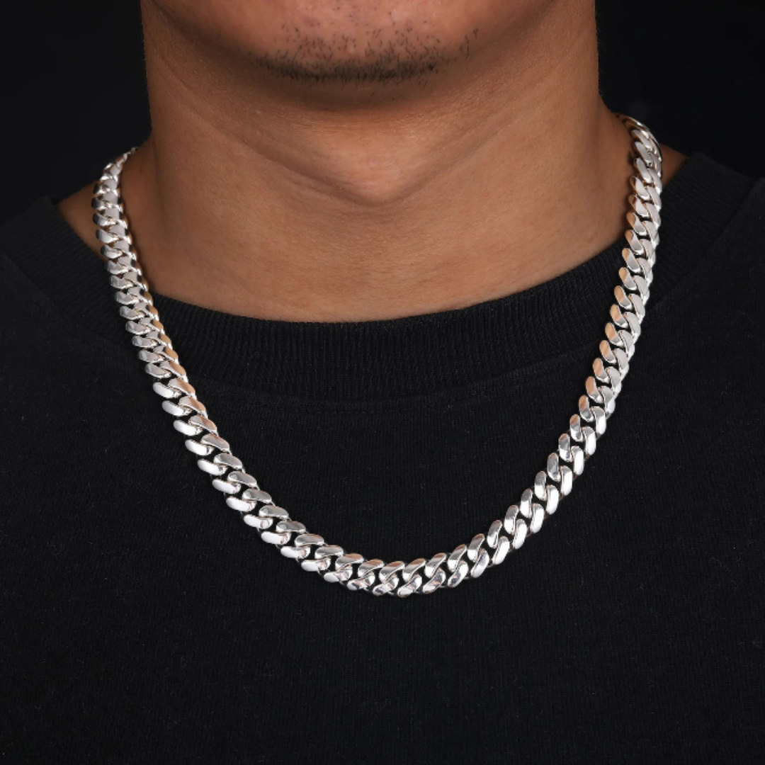 Stylish man wearing a 925 Sterling Silver Cuban Link Chain with White Gold finish, 6MM thick, showcasing a bold and sophisticated accessory.