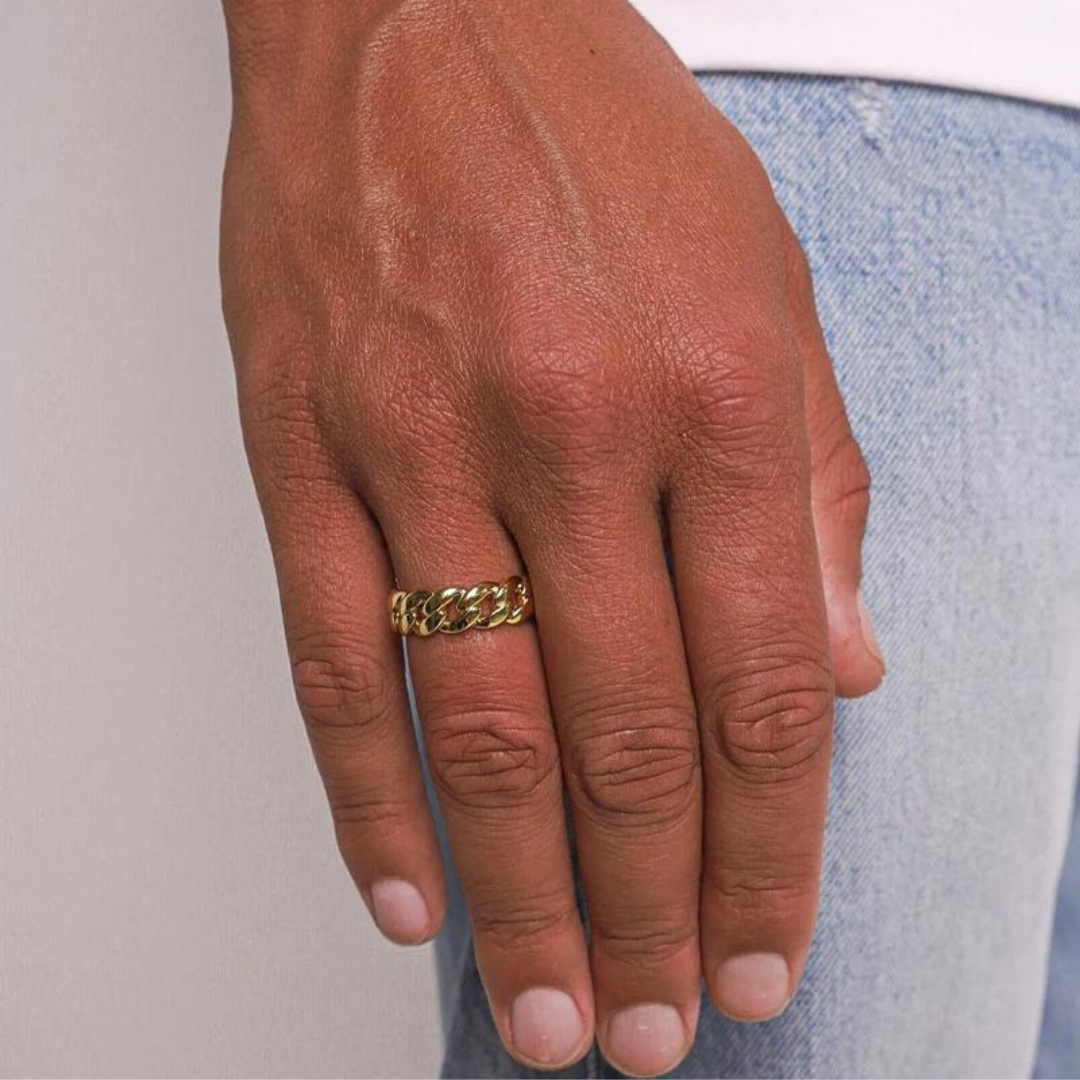 Man showcasing a bold 18K Gold Cuban Link Ring, adding a touch of luxury and sophistication to his look.