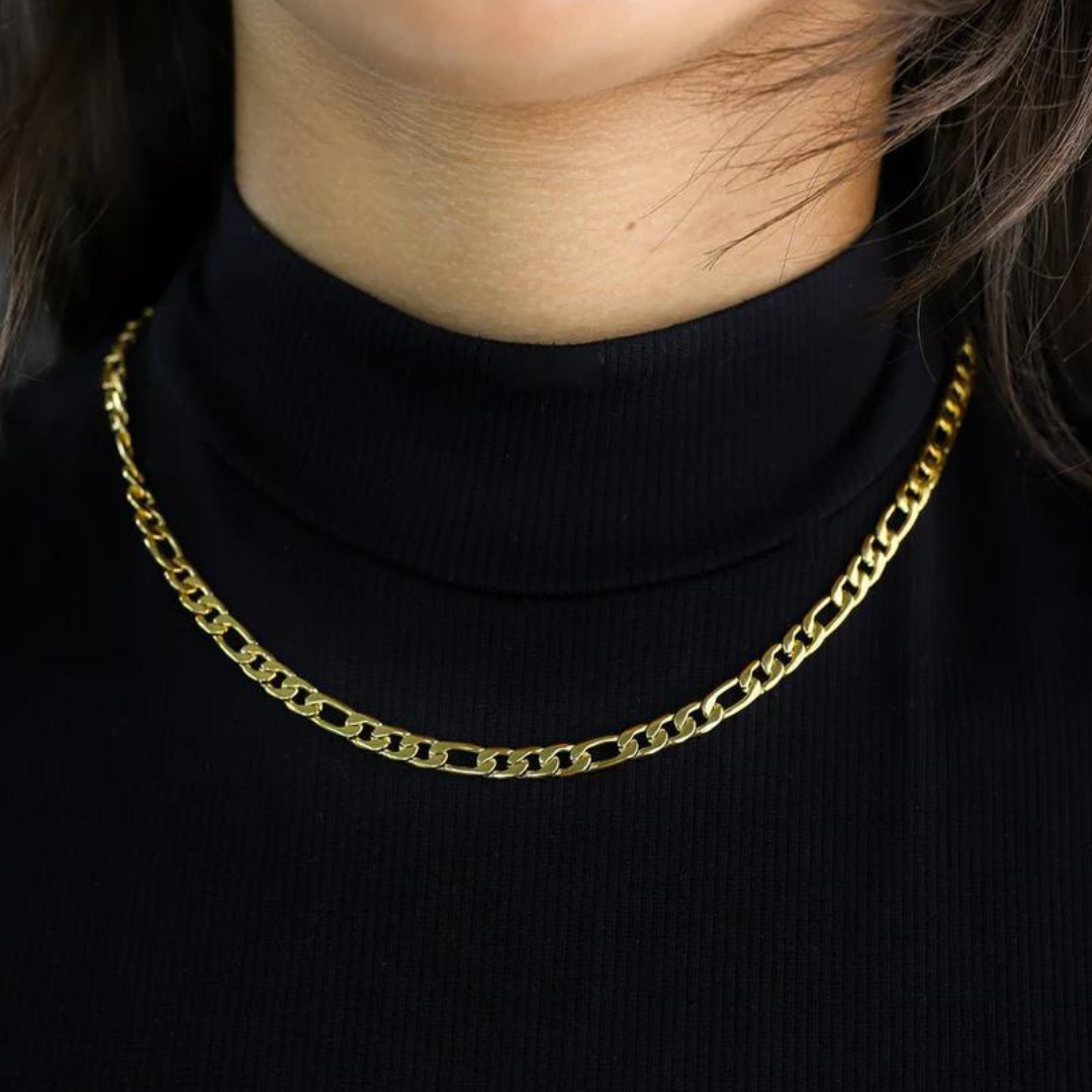 Women's model styling the Figaro Chain in 18K Gold, highlighting an elegant and luxurious piece with a bold 5MM link design.