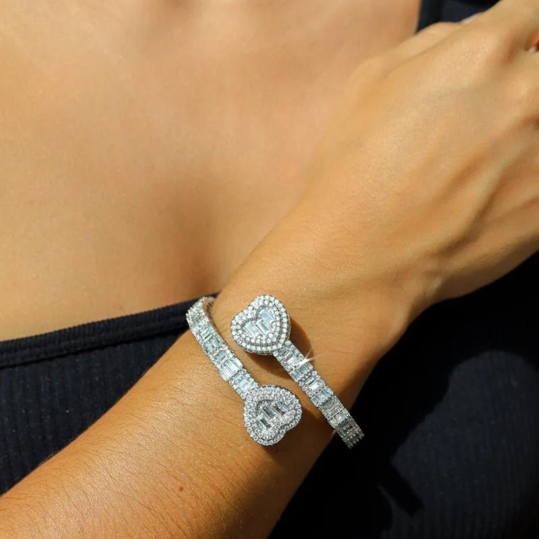 Women's model wearing the Heart Bangle Bracelet in White Gold, highlighting a chic and elegant piece with a sleek, high-polish finish for a luxurious look.