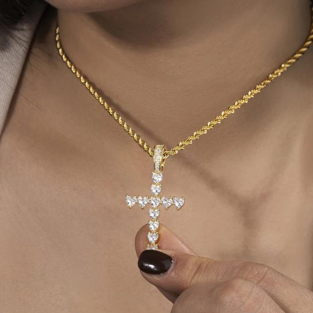 Women's model wearing the Heart Cross Pendant in 18K Gold, featuring an elegant and luxurious piece that combines heart and cross designs for a refined and meaningful touch.