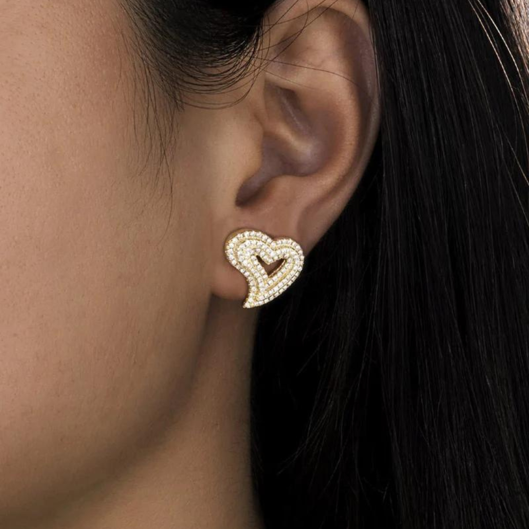 Women's model wearing Heart Stud Earrings in 18K Gold, featuring a chic and elegant design with a polished finish for a timeless and luxurious look.