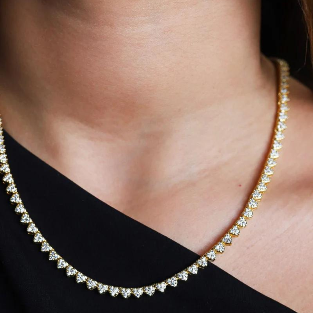 Women's model wearing the Heart Tennis Chain in 18K Gold, highlighting a luxurious and elegant piece with 4MM links and heart-shaped accents for a chic and refined look.