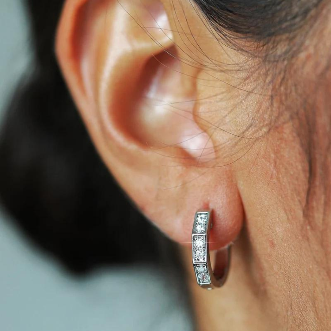 Women's model wearing Hoop Earrings in White Gold, highlighting a chic and timeless design with a high-polish finish for an elegant and luxurious look.