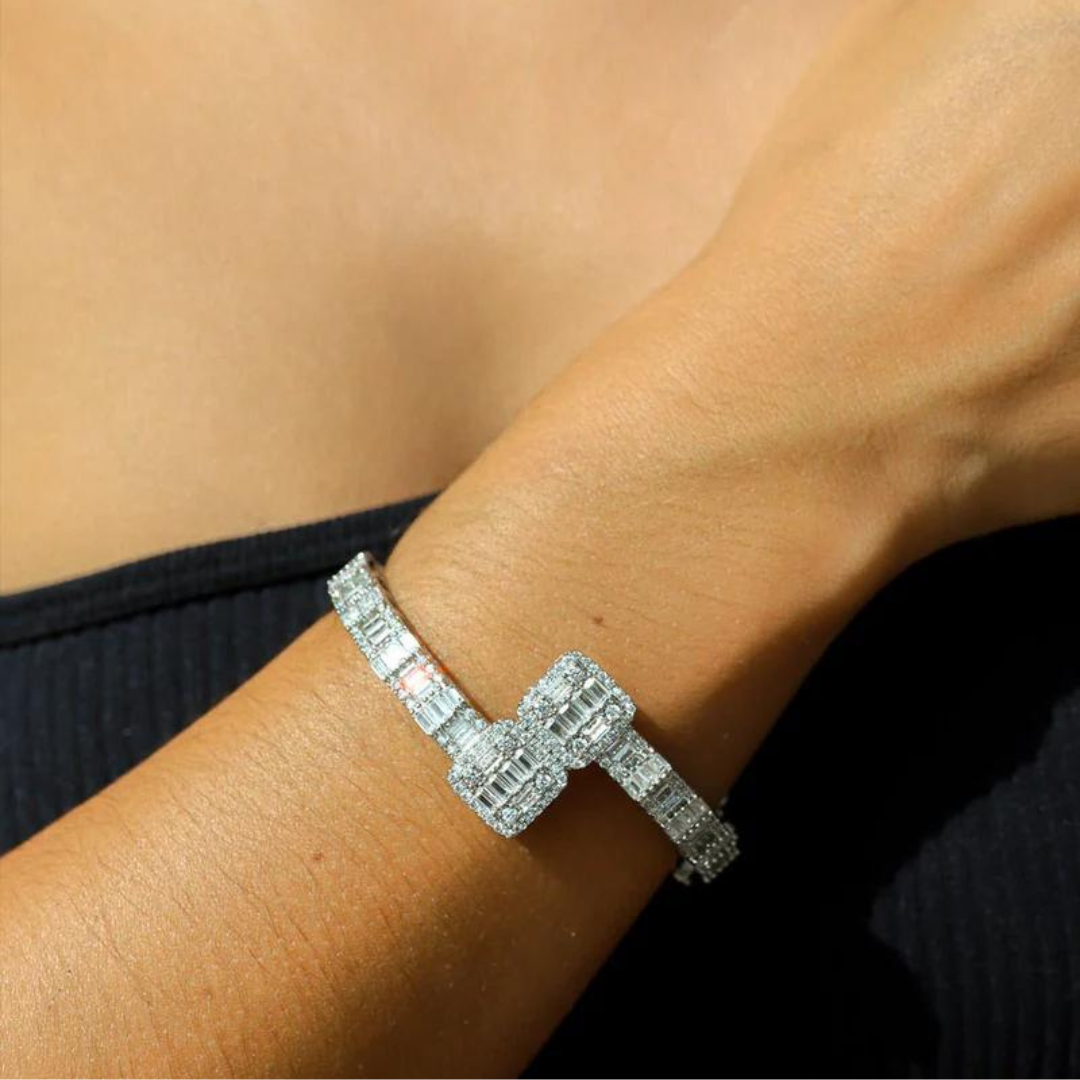 Women's model wearing the Iced Bangle Bracelet in White Gold, highlighting a chic and elegant piece with exquisite gemstone details for a refined and luxurious look.