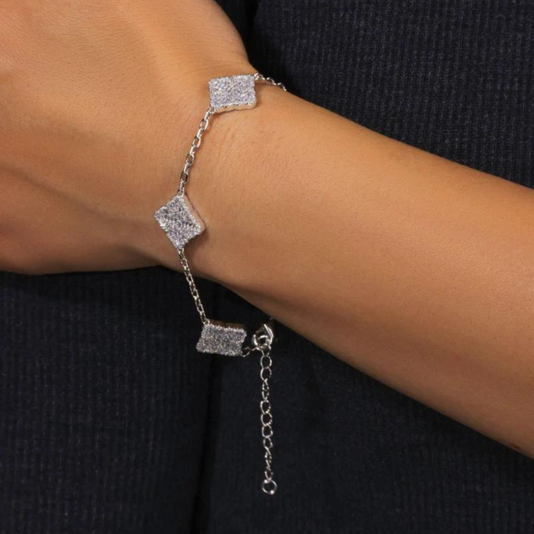 Men's model showcasing the Iced Clover Bracelet in White Gold, featuring a distinct clover design with sparkling gemstones for a refined and stylish accessory.