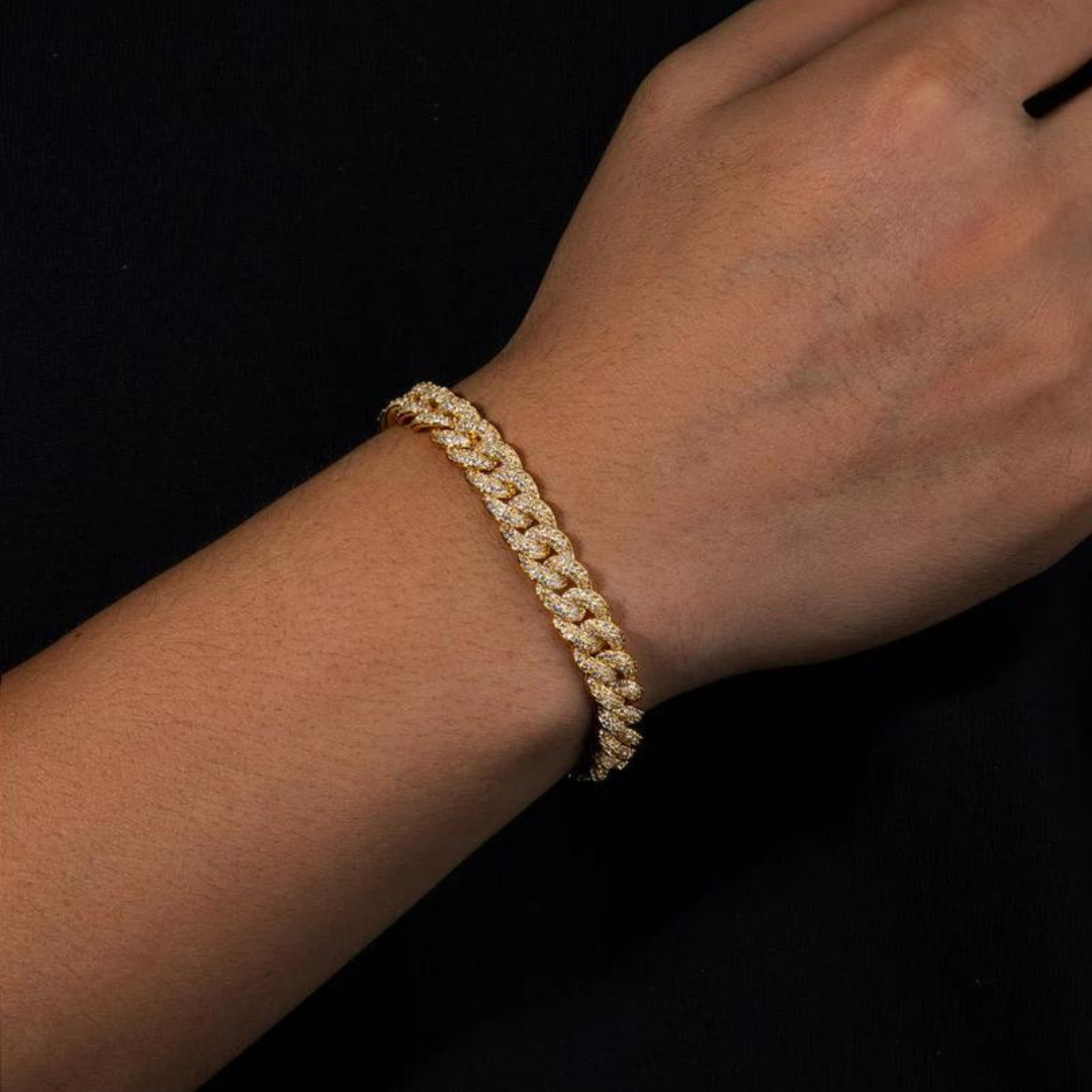 Men's model showcasing the Iced Cuban Link Bracelet in 18K Gold with 8MM links, featuring a bold design with dazzling gemstones for a sophisticated and standout look.