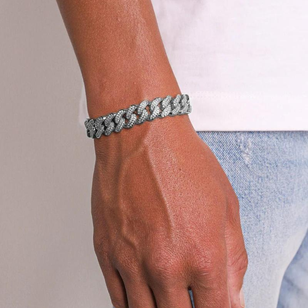  Men's model showcasing the Iced Cuban Link Bracelet in White Gold with 12MM links, featuring a powerful design with dazzling gemstones for a sophisticated and eye-catching accessory.