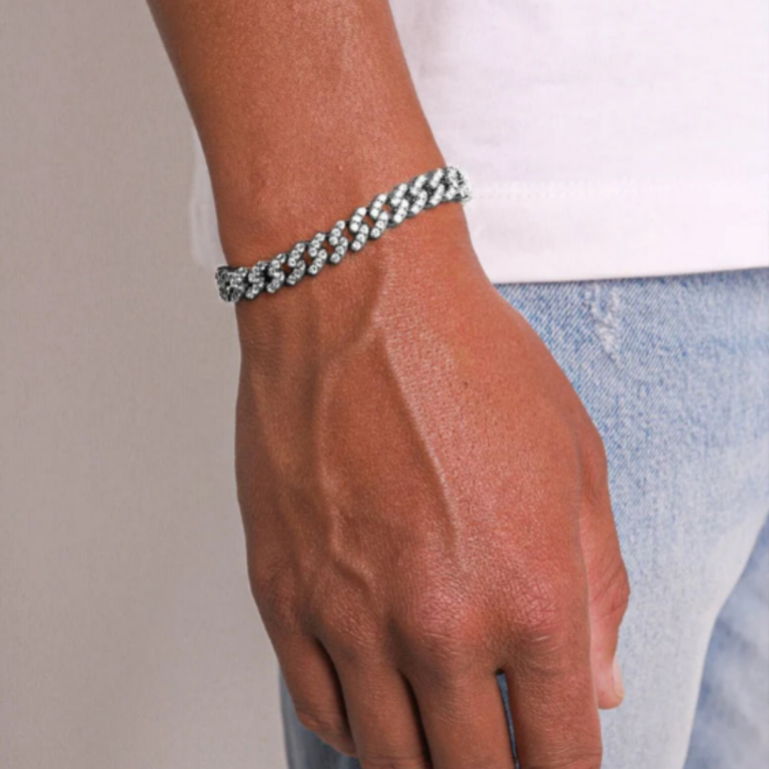 Men's model showcasing the Iced Cuban Link Bracelet in White Gold with 9MM links, featuring a bold and stylish design with dazzling gemstones for a refined and impactful accessory.