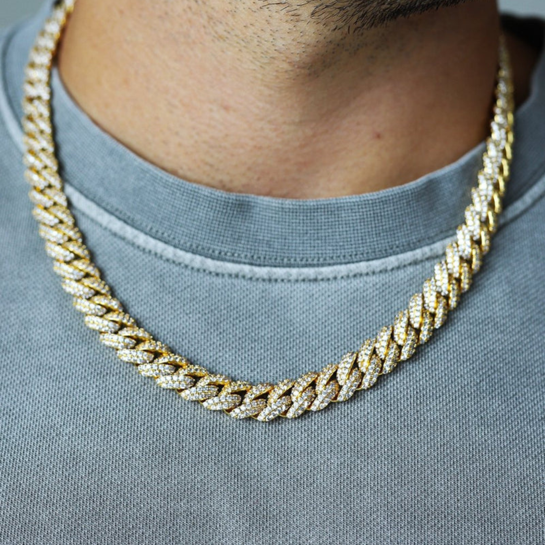 Men's model showcasing the Iced Cuban Link Chain in 18K Gold with 10MM links, featuring a powerful design with dazzling gemstones for a sophisticated and high-impact accessory.