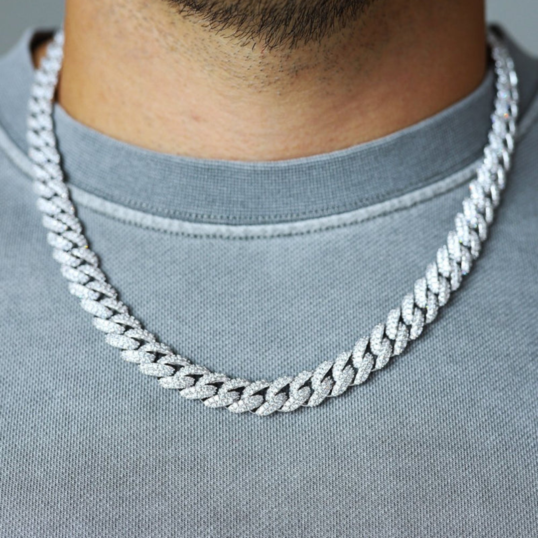 Men's model showcasing the Iced Cuban Link Chain in White Gold with 10MM links, featuring a powerful design with dazzling gemstones for a sophisticated and high-impact accessory.