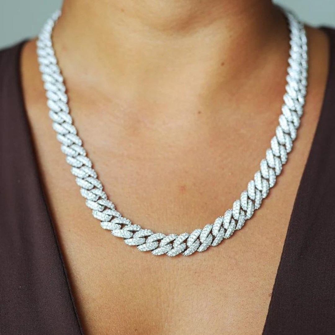 Women's model wearing the Iced Cuban Link Chain in White Gold with 10MM links, highlighting a chic and luxurious piece with intricate detailing and sparkling gemstones for an elegant and refined look.