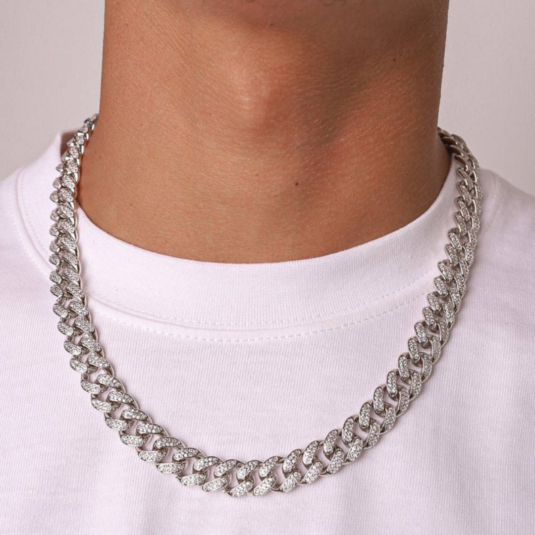 Men's model showcasing the Iced Cuban Link Chain in White Gold with 12MM links, featuring a striking design with dazzling gemstones for a sophisticated and high-impact accessory.