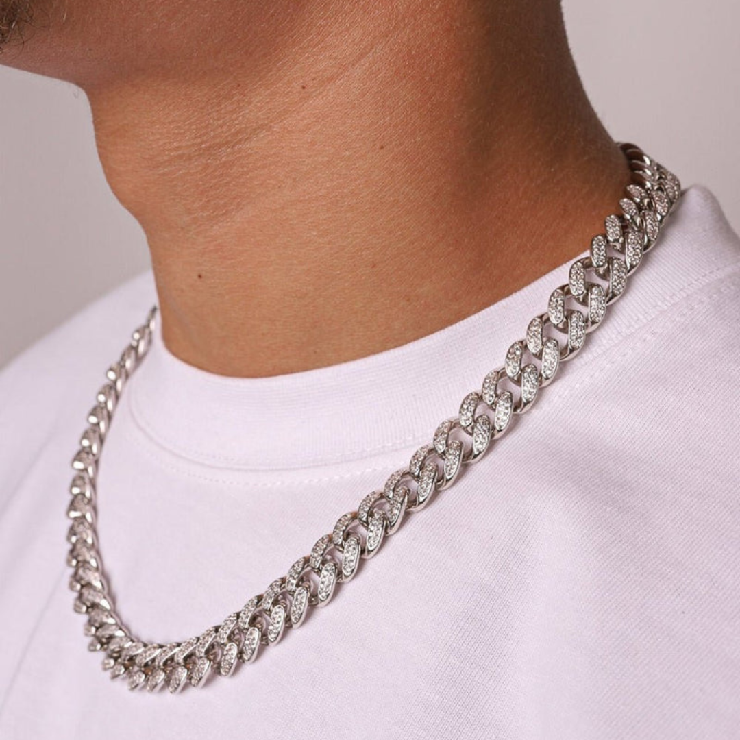 Men's model displaying the Iced Cuban Link Chain in White Gold with 12MM links from a different angle, emphasizing the bold design and dazzling gemstones for a high-impact, sophisticated accessory.