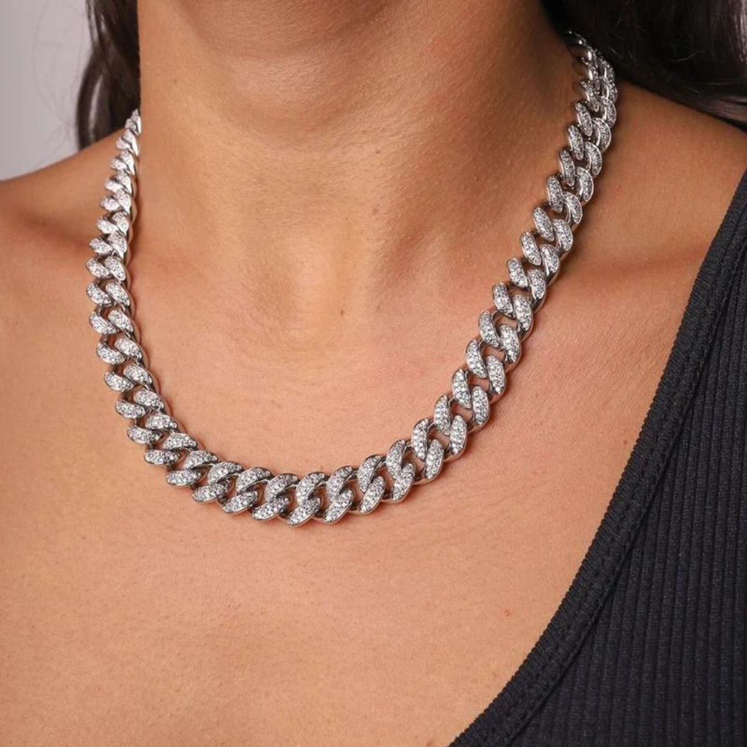 Women's model showcasing the Iced Cuban Link Chain in White Gold with 12MM links from an alternative perspective, highlighting the luxurious design and sparkling gemstones for a stylish and high-end appearance.