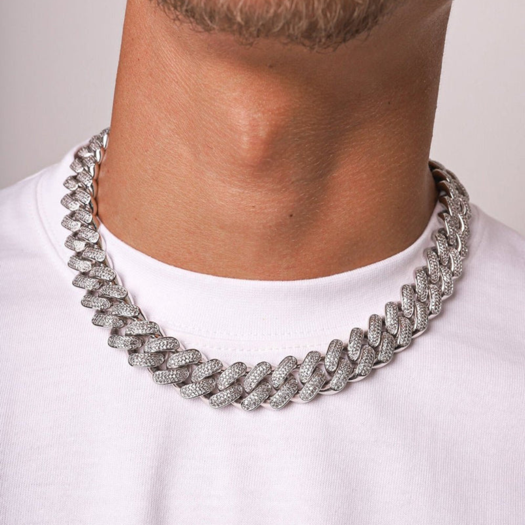 Men's model showcasing the Iced Cuban Link Chain in White Gold with 20MM links, featuring an impressive design with sparkling gemstones for a bold and sophisticated accessory.