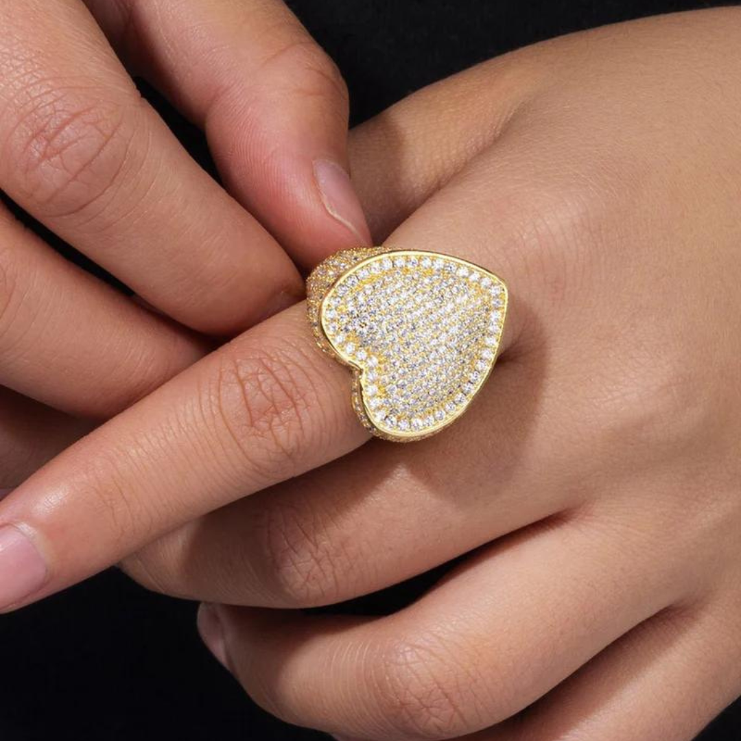 Women's model wearing the Iced Heart Ring in 18K Gold, highlighting a chic and elegant heart-shaped piece with intricate detailing and dazzling gemstones for a refined and stylish look.