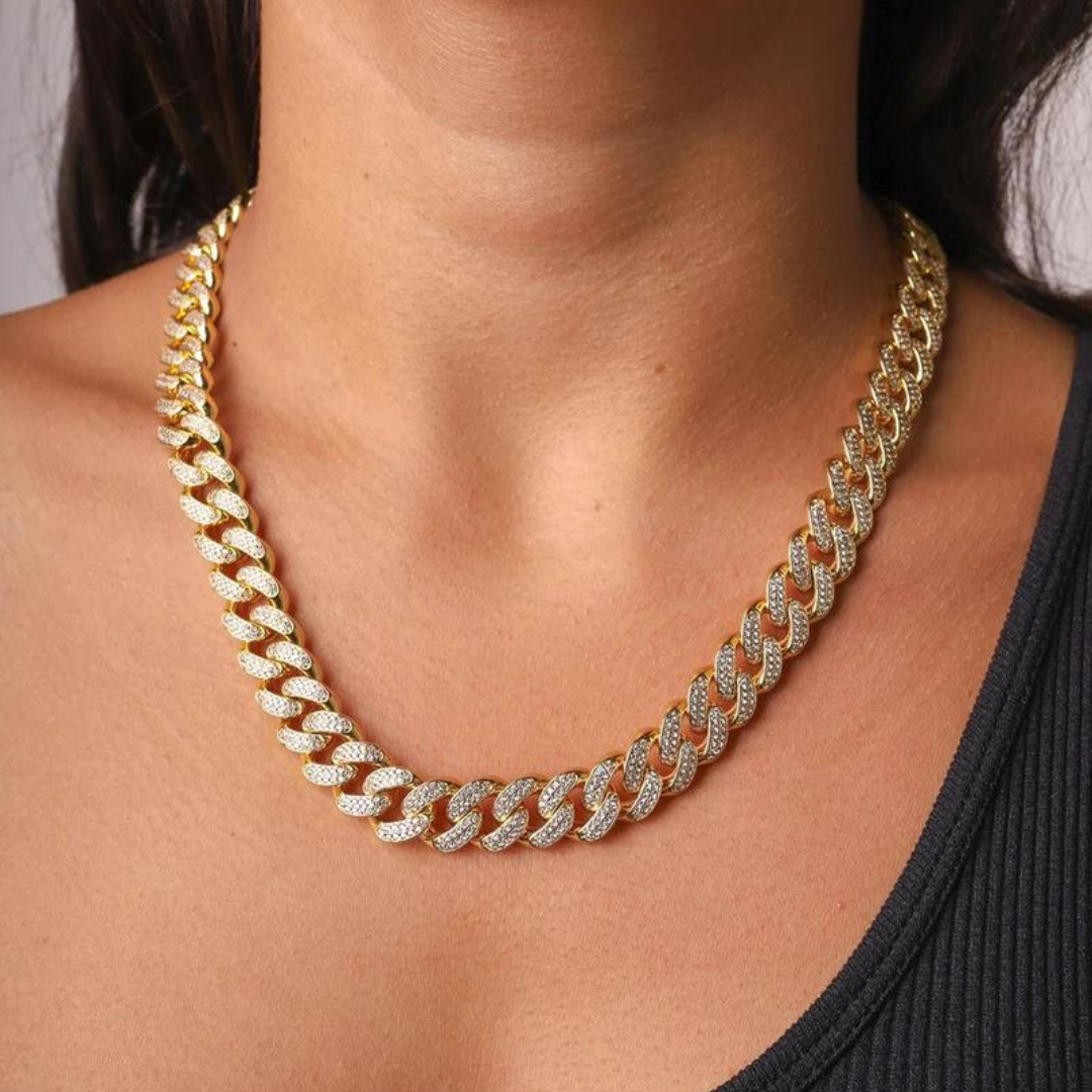 Women's model wearing the Iced Cuban Link Chain in 18K Gold with 10MM links, highlighting a luxurious and eye-catching piece with intricate detailing and sparkling gemstones for a refined and elegant look.