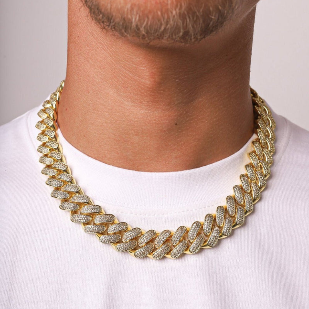 Men's model showcasing the Iced Cuban Link Chain in 18K Gold with 20MM links, featuring an impressive design with dazzling gemstones for a bold and sophisticated accessory.