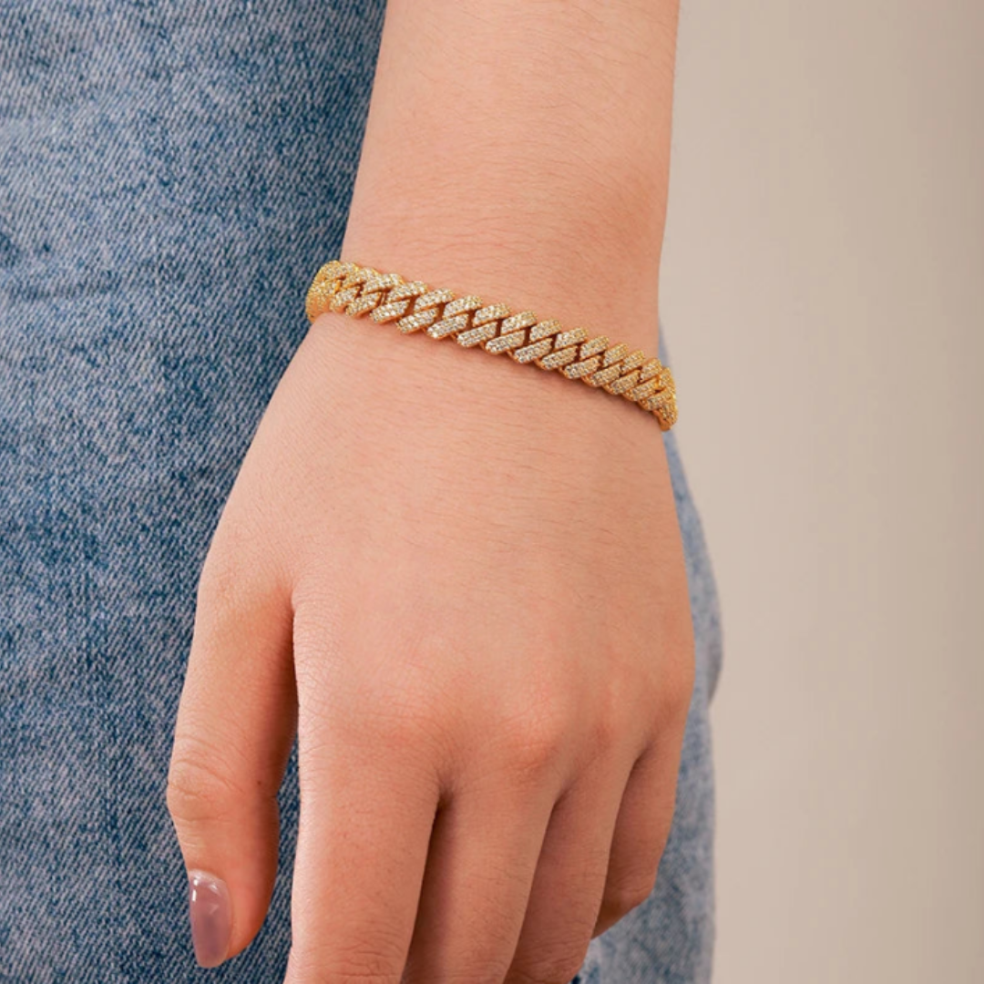 Women's model wearing the Iced Prong Bracelet in 18K Gold with 9MM links, highlighting a chic and opulent piece with prong-set gemstones for an elegant and stylish look.