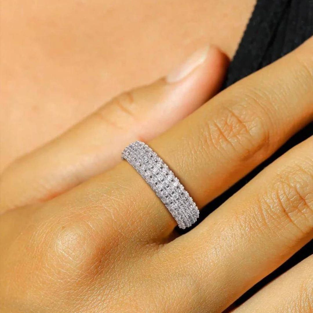 Women's model wearing the Iced Ring in 925 Sterling Silver with a White Gold finish, highlighting an elegant and opulent piece with prong-set gemstones for a stylish and sophisticated look.