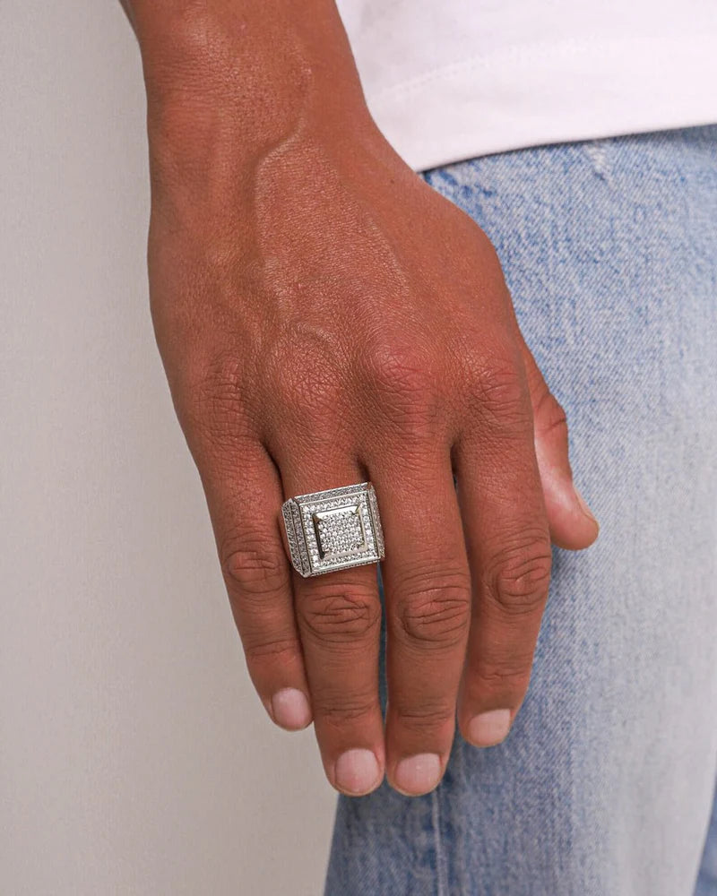 Men's model showcasing the Iced Signet Ring in 925 Sterling Silver with a White Gold finish, featuring a refined design with prong-set gemstones for a bold and luxurious accessory.