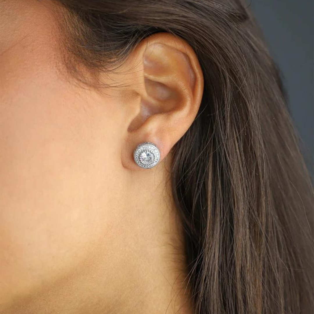 Women's model wearing the Iced Studs in 925 Sterling Silver with a White Gold finish, highlighting a chic and elegant design with prong-set gemstones for a stylish and high-end appearance.