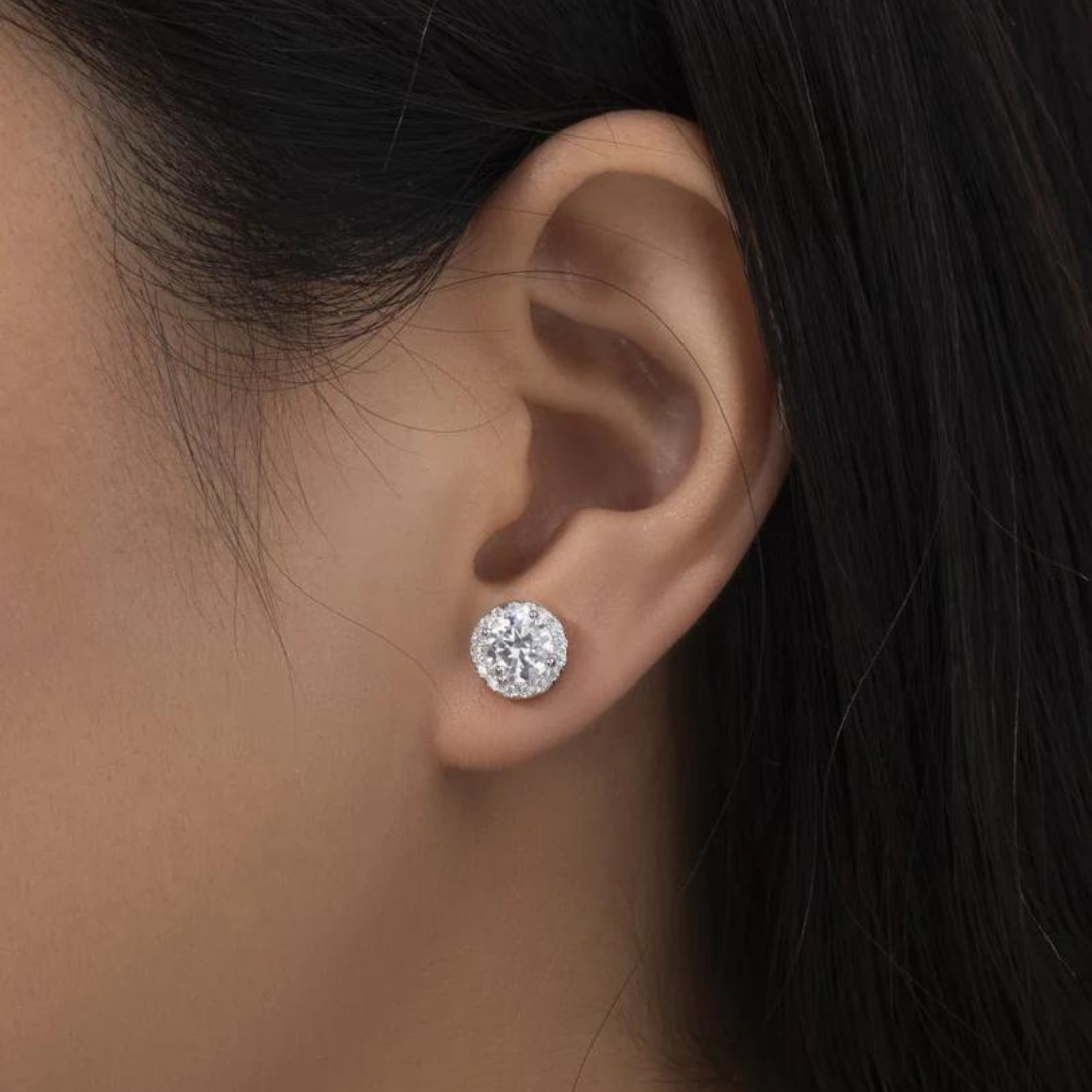 Women's model wearing the Royal Crystal Studs in 925 Sterling Silver and White Gold with Moissanite stones, emphasizing their elegant design and luxurious sparkle for a chic and refined appearance.