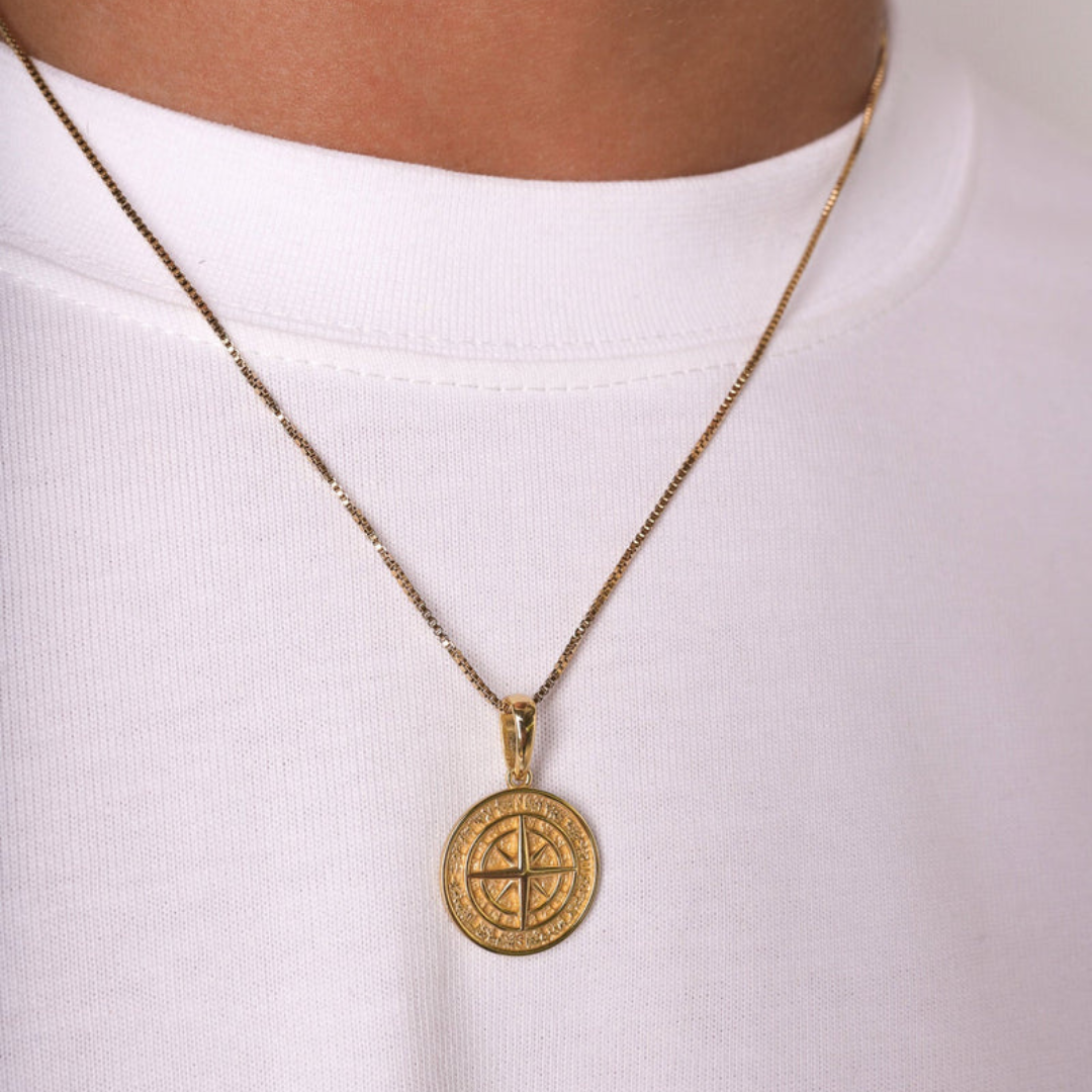 Men's model displaying the Solid Compass Pendant in 925 Sterling Silver and 14K Gold, including a free chain, from a different angle, showcasing its classic design and opulent finish for a high-impact accessory.