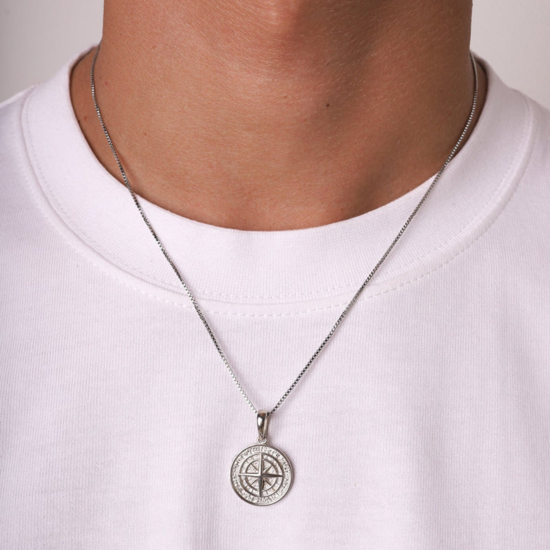 Men's model showcasing the Solid Compass Pendant in 925 Sterling Silver with White Gold finish, including a free chain, highlighting its sophisticated design and high-quality finish for a stylish and refined statement.