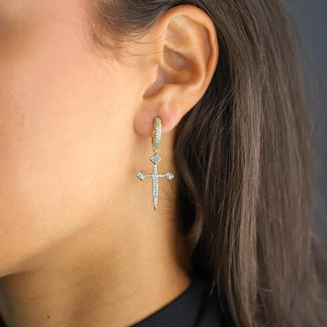 Women's model wearing the Sword Earrings in 14K Gold, emphasizing their unique sword design and elegant finish for a chic and bold look.