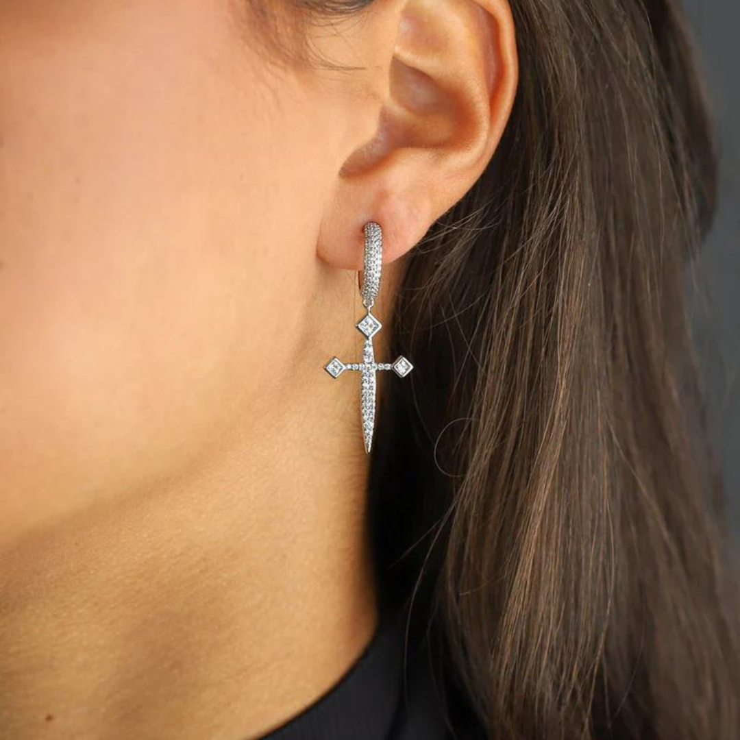 Women's model wearing the Sword Earrings in White Gold, emphasizing their unique sword design and elegant finish for a chic and bold look.