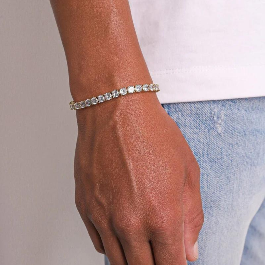 Men's model showcasing the Tennis Bracelet in 18K Gold with 5MM links, highlighting its bold design and luxurious finish for a refined and high-impact accessory.