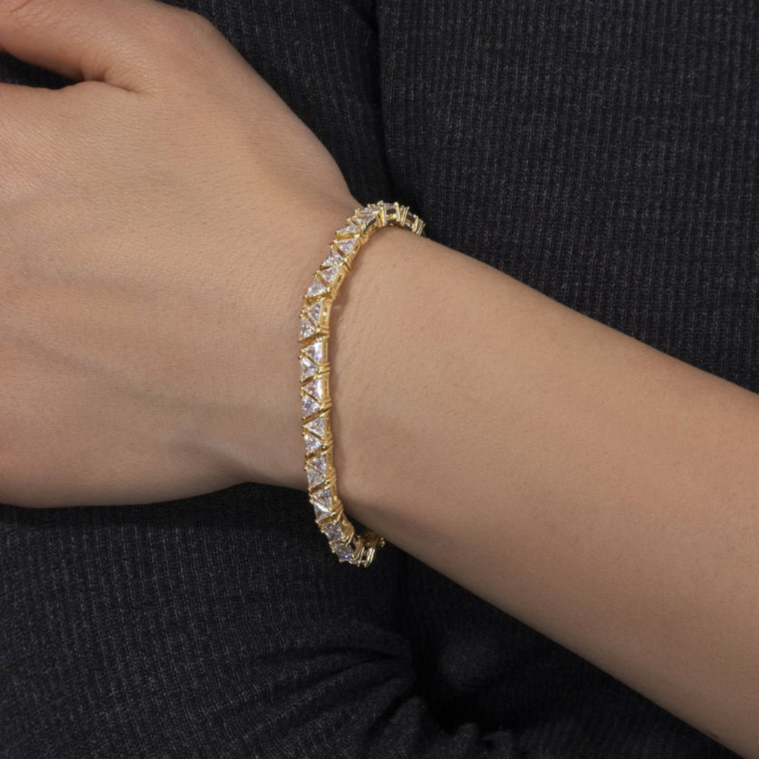 Men's model showcasing the Triangle Tennis Bracelet in 18K Gold with 5MM links, highlighting its bold and distinctive design for a high-impact accessory that exudes luxury and style.