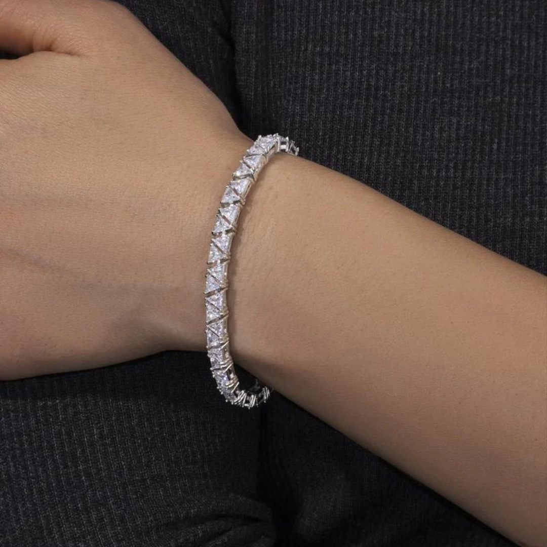 Men's model showcasing the Triangle Tennis Bracelet in White Gold with 5MM links, highlighting its bold and unique design for a high-impact accessory that exudes sophistication and style.