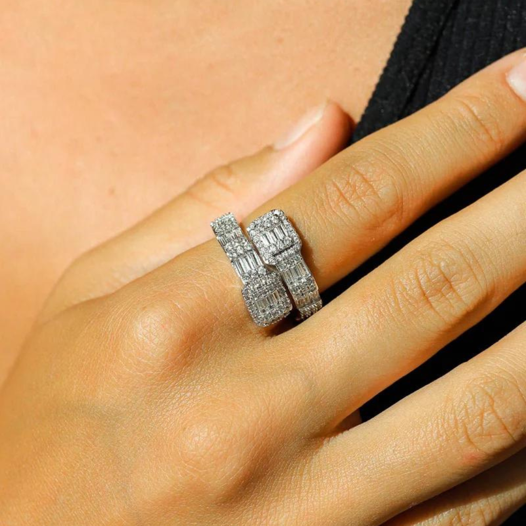 Women model's hand showcasing a white gold baguette ring, emphasizing the sparkling baguette-cut stones against a chic, modern setting.