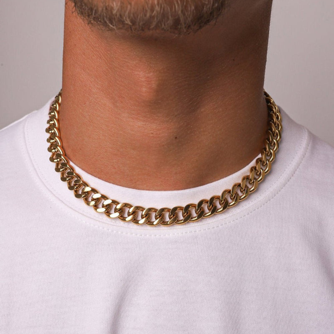 Men's model wearing an 18k gold Cuban link chain with a 12mm width, showcasing its striking design and radiant shine against a fashionable and contemporary outfit.