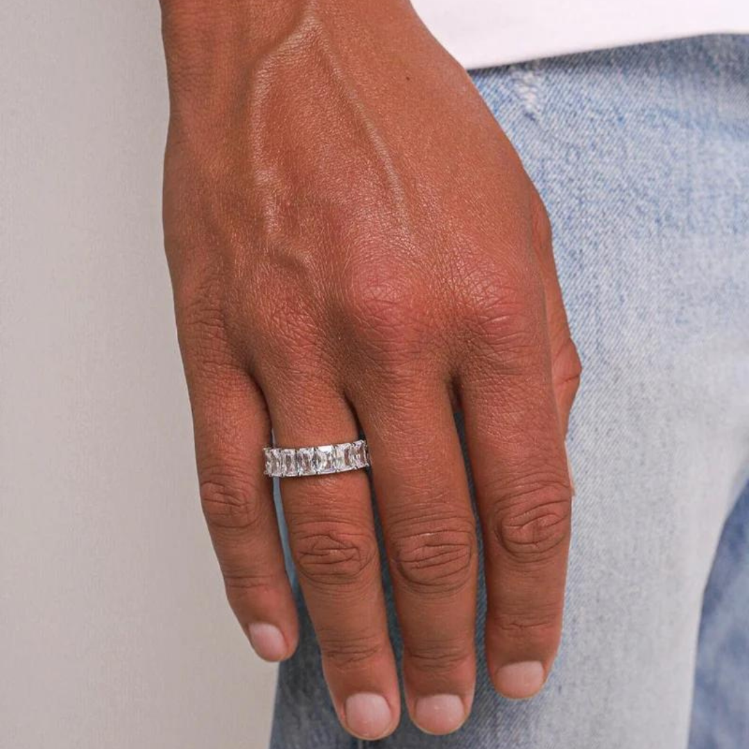 Male model’s hand adorned with a white gold clarity ring, showcasing the dazzling centerpiece and elegant design against a sophisticated backdrop.