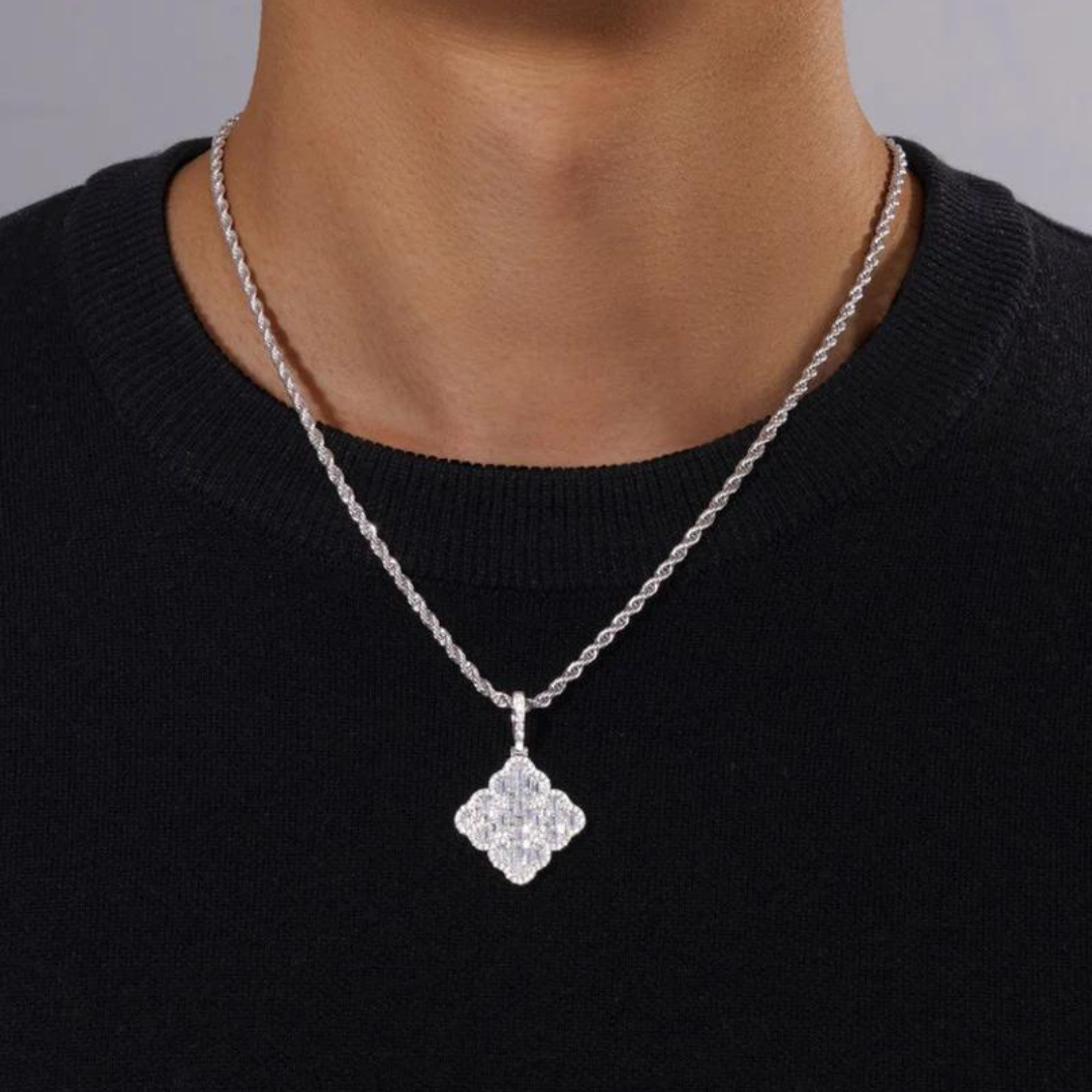 Men's model wearing a white gold clover pendant, emphasizing its intricate design and subtle shine against a chic, modern outfit.