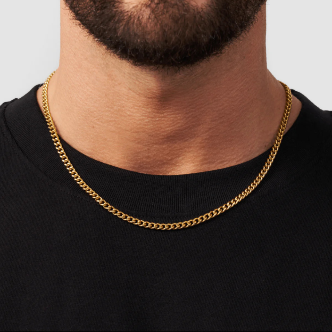 Model wearing an 18k gold Cuban link chain with a 4mm width, showcasing its refined design and elegant shine against a stylish and contemporary outfit.