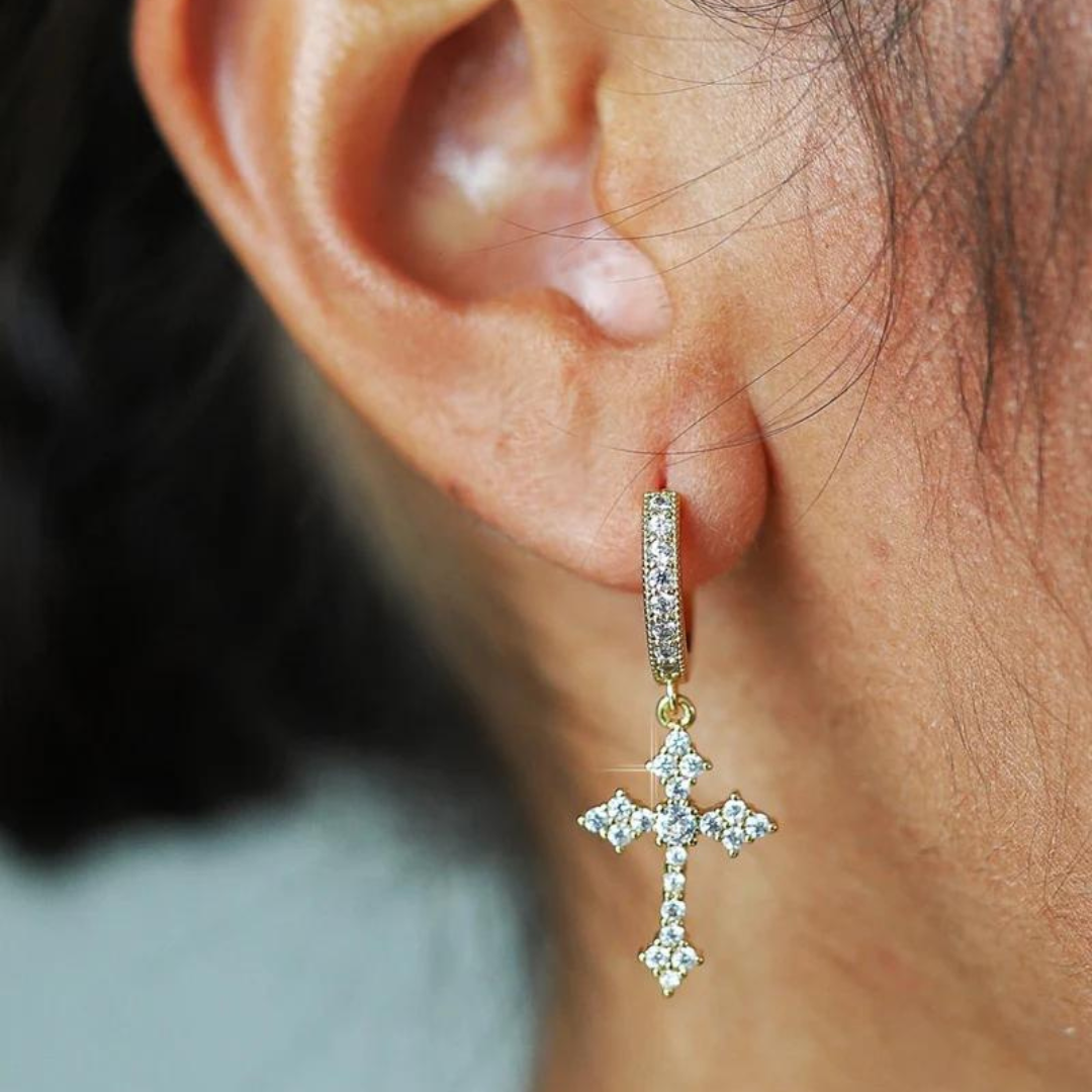 Model wearing white gold cross earrings, showcasing their refined design and elegant shine against a chic, modern outfit.