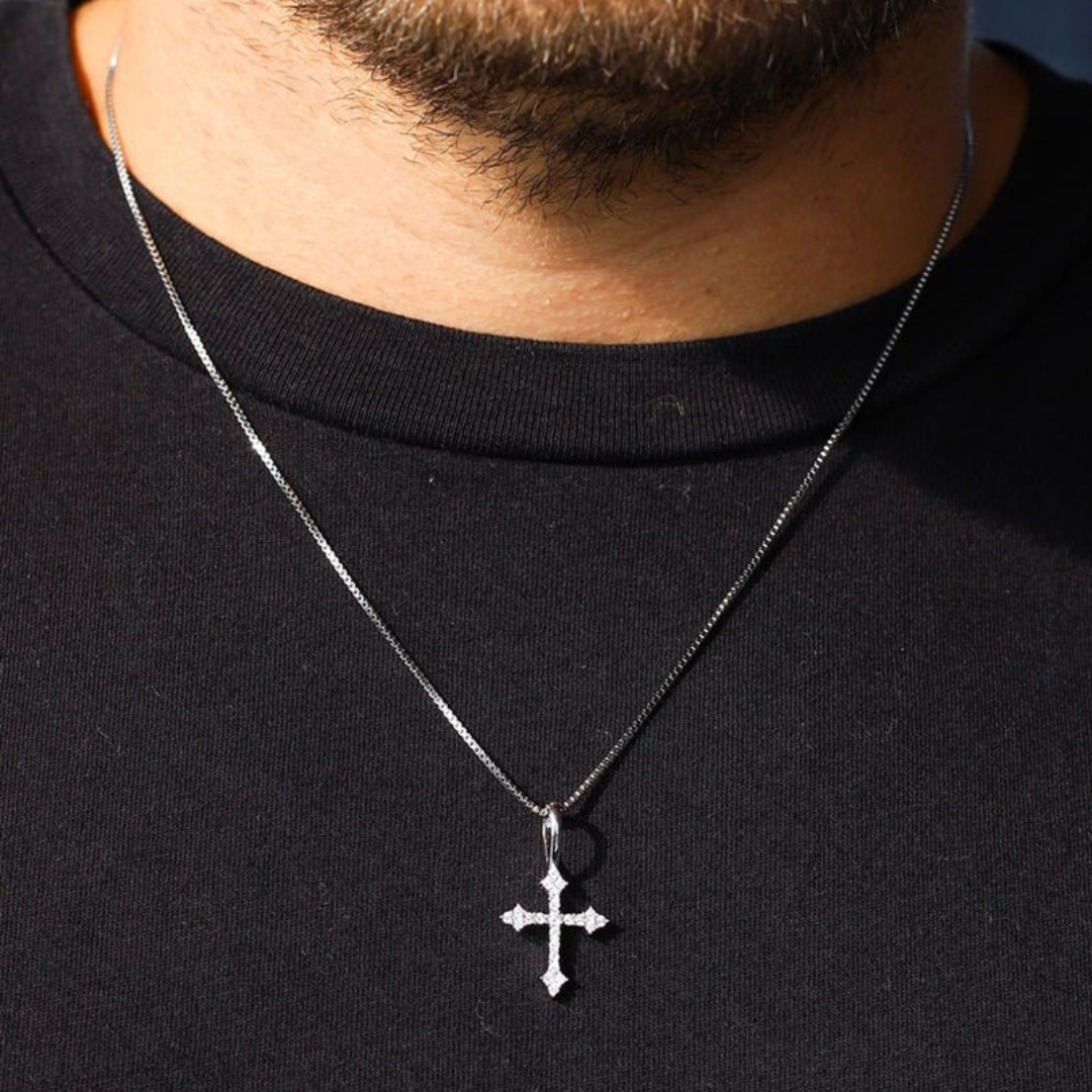 Model wearing a 925 sterling silver cross pendant with white gold accents, showcasing the elegant design and subtle shine against a fashionable outfit.