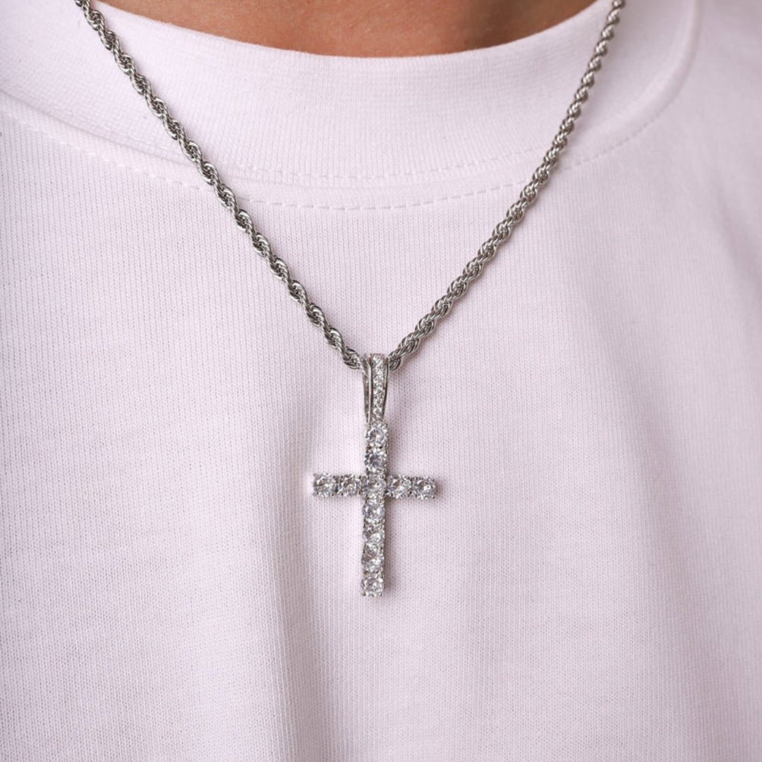 Model wearing a white gold cross pendant with crystal accents, highlighting the pendant’s elegant sparkle and sophisticated design against a stylish outfit.