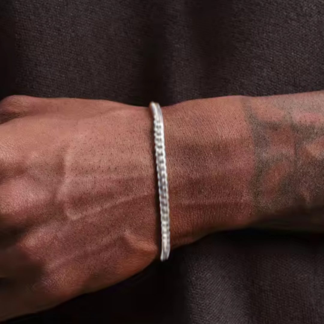 Men's model showcasing the Cuban Link Bracelet in White Gold with a 5MM width, emphasizing its sleek and sophisticated design for a stylish and eye-catching accessory made for flair and elegance.