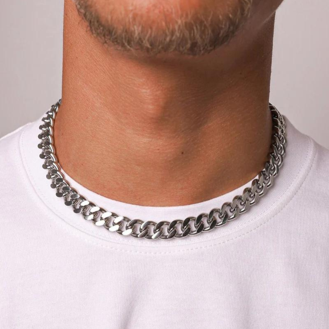 Mens model wearing a white gold Cuban link chain with a 12mm width, highlighting its impressive design and elegant shine against a stylish outfit.