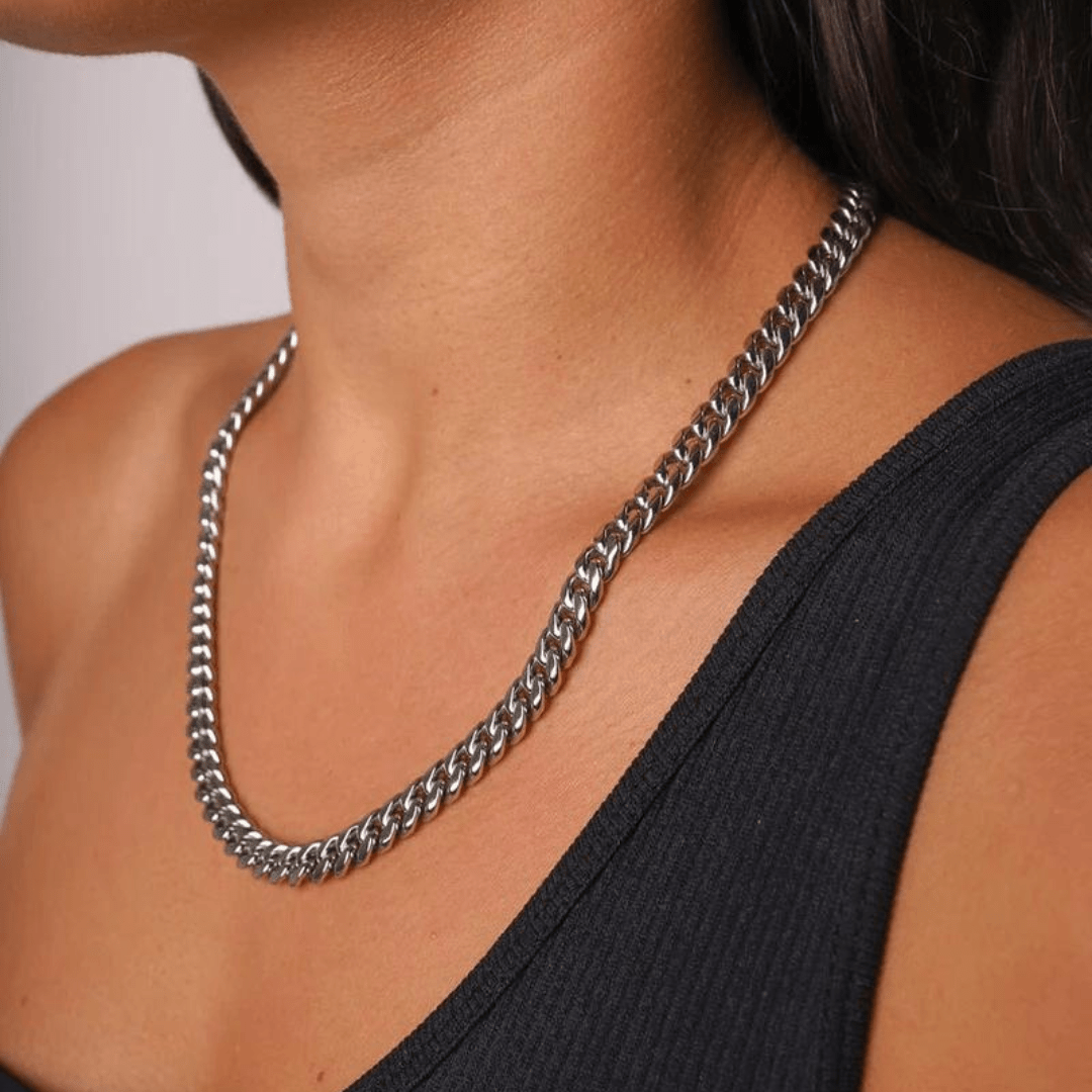 Womens model showcasing a cuban link chain in white gold.